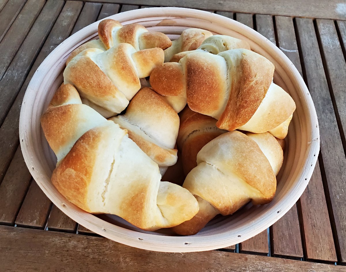 https://honestandtruly.com/buttery-crescent-rolls-recipe/basket-of-golden-brown-crescent-rolls-on-a-wooden-table/