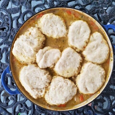 Chicken stew with biscuits on a filigreed table