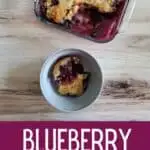 Overhead of cake in a bowl with pan and text blueberry dump cake.