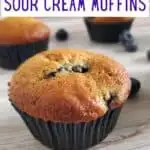 Close up of blueberry muffin with text blueberry sour cream muffins.