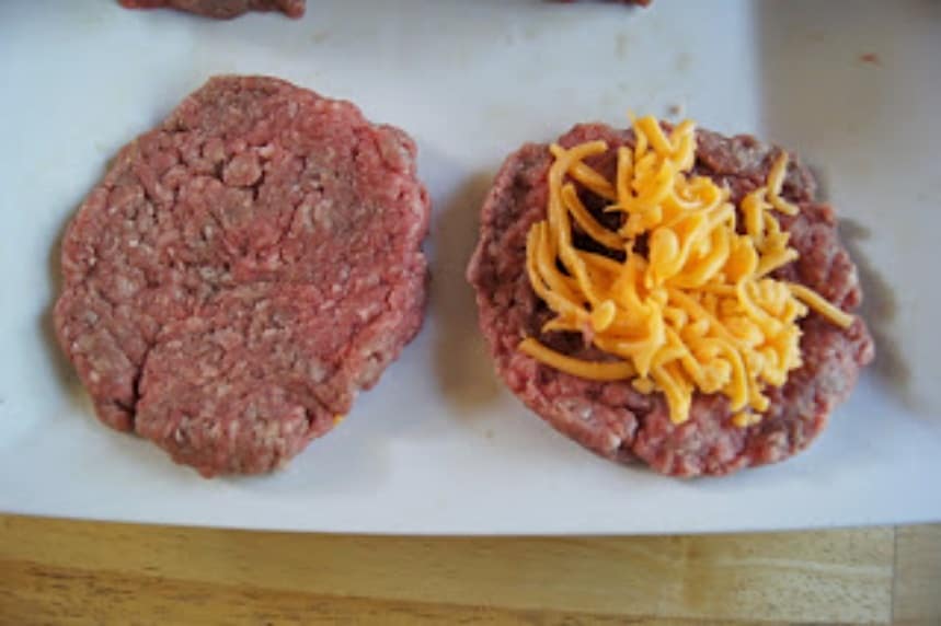 Cheese atop a patty about to get topped by a second patty.