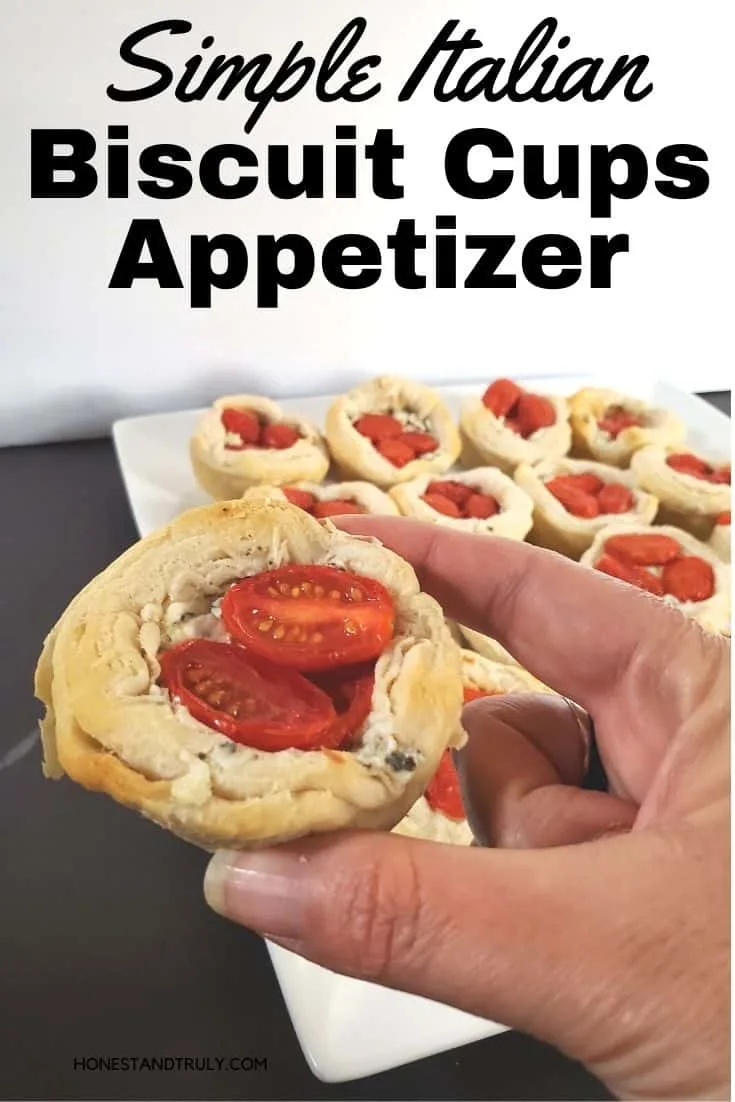 Hand holding biscuit appetizer over tray