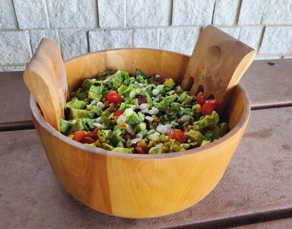 Tomato avocado salad on a picnic table.