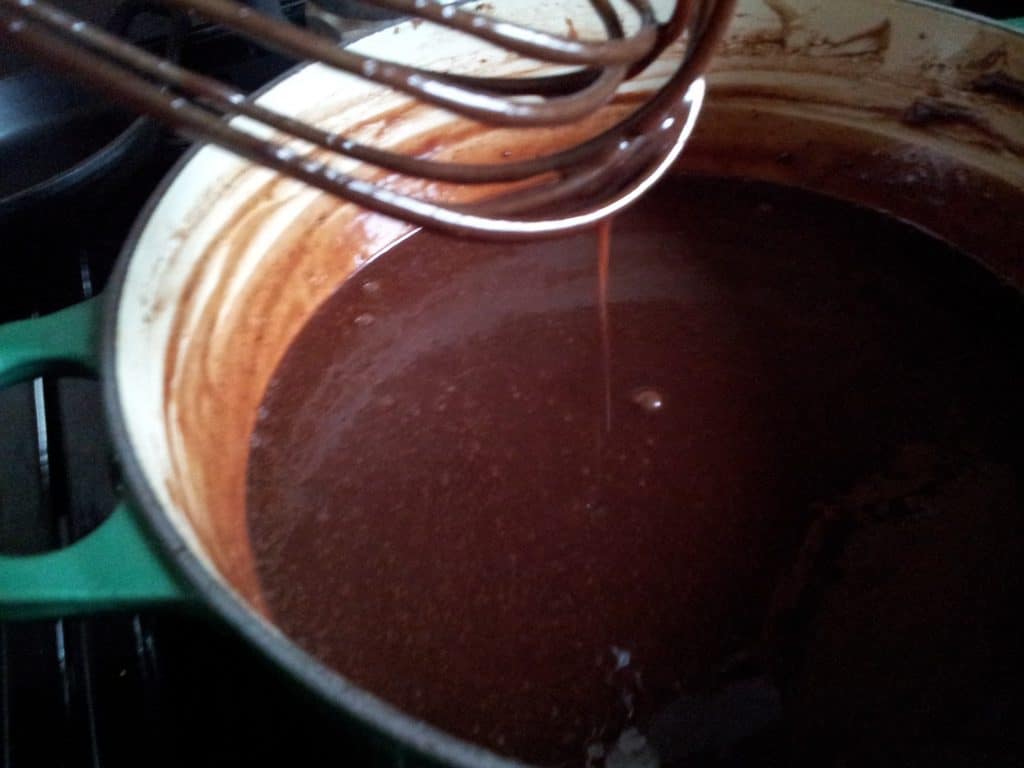 Hot Fudge sauce dripping off whisk