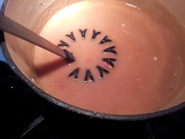 Cooking gravy with a whisk to prevent lumps