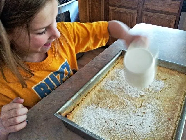 Little Miss adding powdered sugar