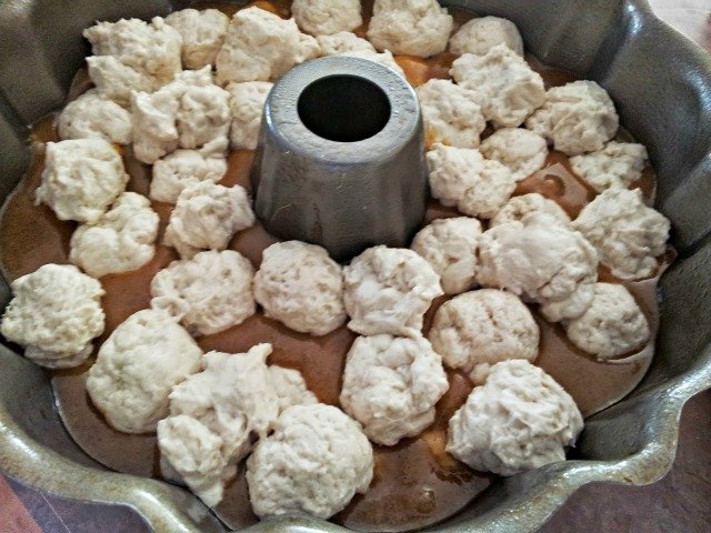 Roll the rest of the dough into balls and place into the bundt pan.  It's ok if they don't cover the sauce or fill the pan