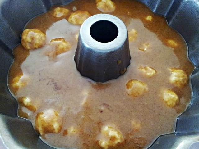 Pour the sauce over the half of the dough balls you've placed in the bundt pan