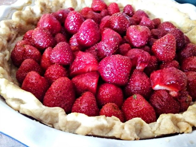 Pie with strawberries ready to be glazed