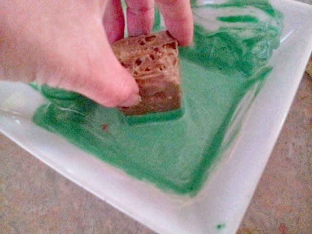 Dip dirt squares into green chocolate to make grassy tops