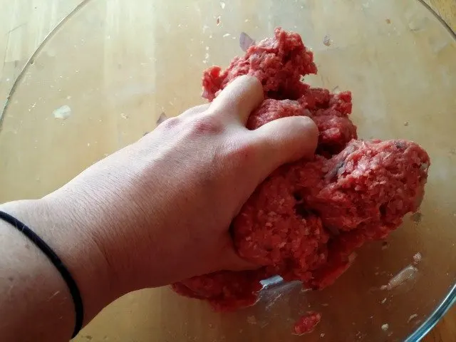 Use your hands to mix together the meatball ingredients