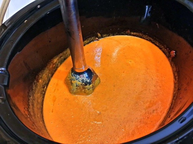 Immersion blender pureeing the sauce