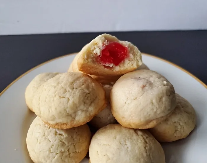 Using a cookie scoop or tablespoon, drop mounds of dough 1 inch apart onto  parchment paper lined baking sheet. Flatten each cookie slightly. Bake for  8 to 10 minutes or until the