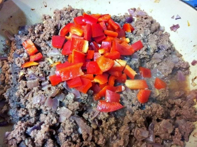 Red peppers are added after most of the cooking is done to ensure they stay slightly crunchy
