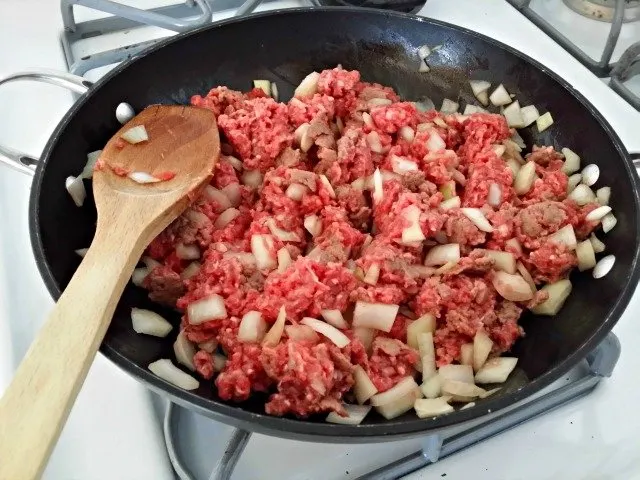 Add ground beef to lightly sauteed onions