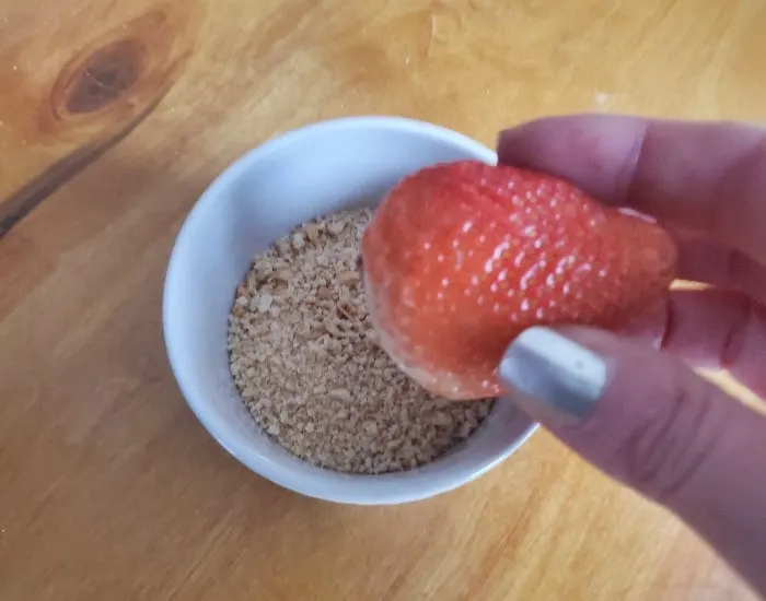 Dip strawberry in crumbs