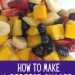 Image shows a Closeup of tropical fruit salad with text how to make a perfect summer fruit salad.