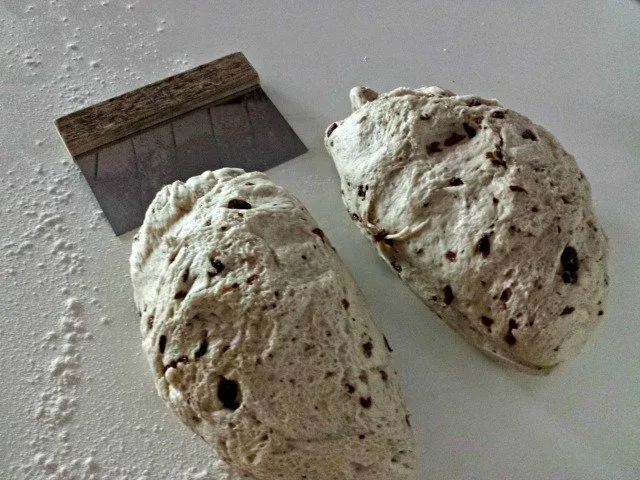 Cut your dough into two equal size pieces to make your cinnamon raisin loaves