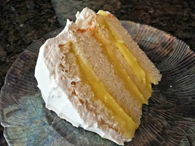 Beautiful slice of 4 layer lemon filled cake