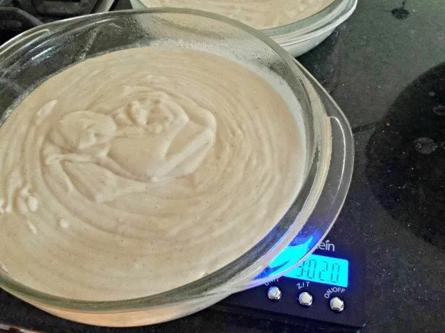 Divide your cake batter equally into  pans using a kitchen scale