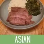 Meat and greens and rice on a blue plate with text asian marinated steak.