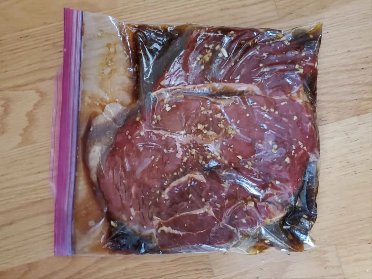 Zip top bag with steak marinating in Asian flavors.