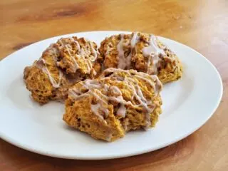 Three pumpkin scones on a white plate