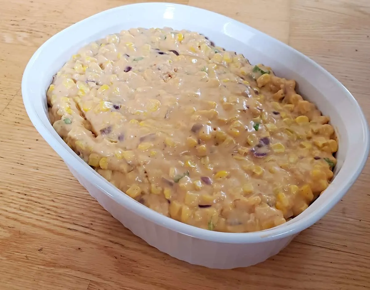 Corn casserole filling in a baking dish.