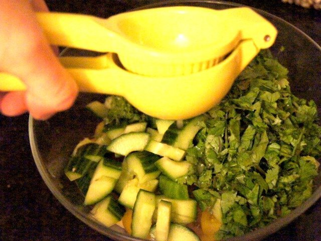juicing a lime into hearts of palm salad