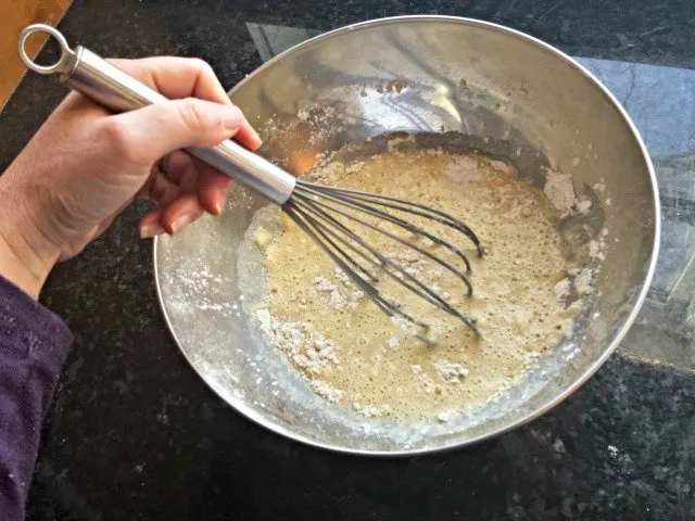 Stir blueberry pancakes gently with a whisk
