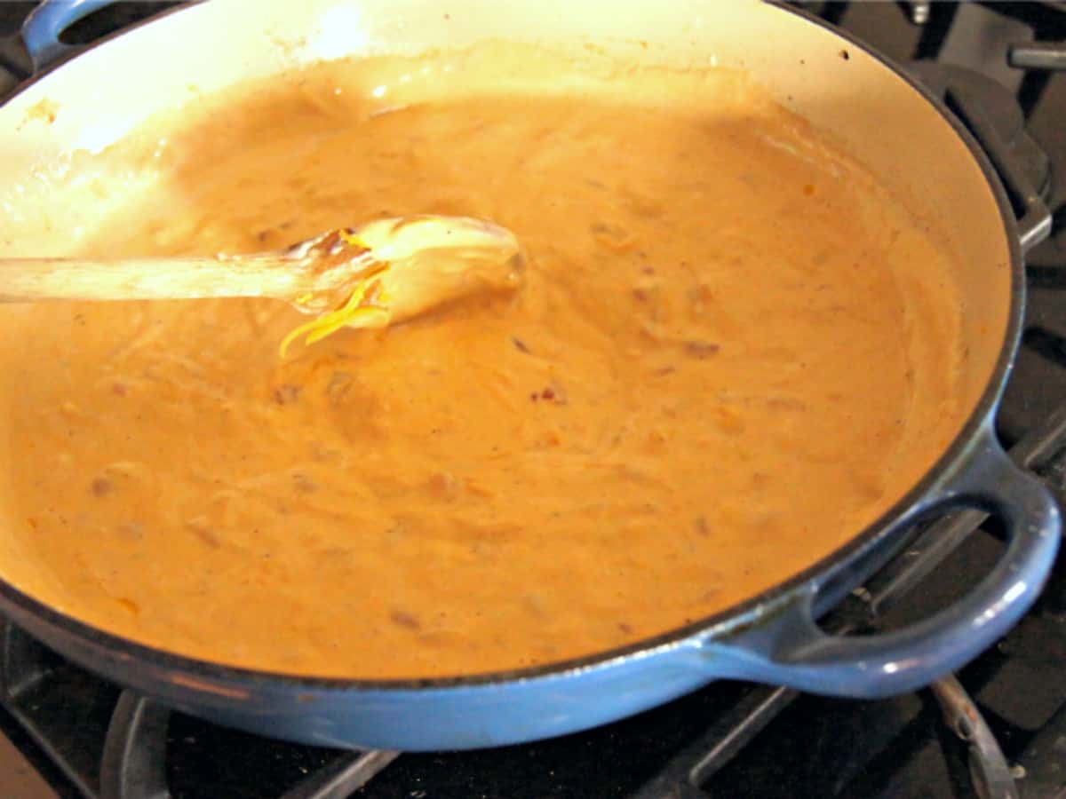 Stirring cheese sauce in a pan