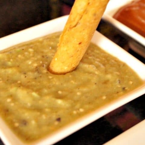 Dipping taquitos in roasted tomatillo salsa