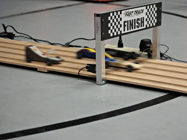 Racing Pinewood Derby cars on the track