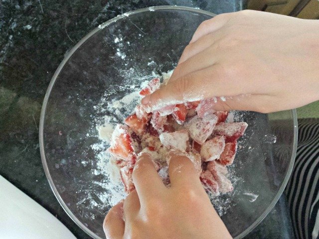 Toss strawberries with flour