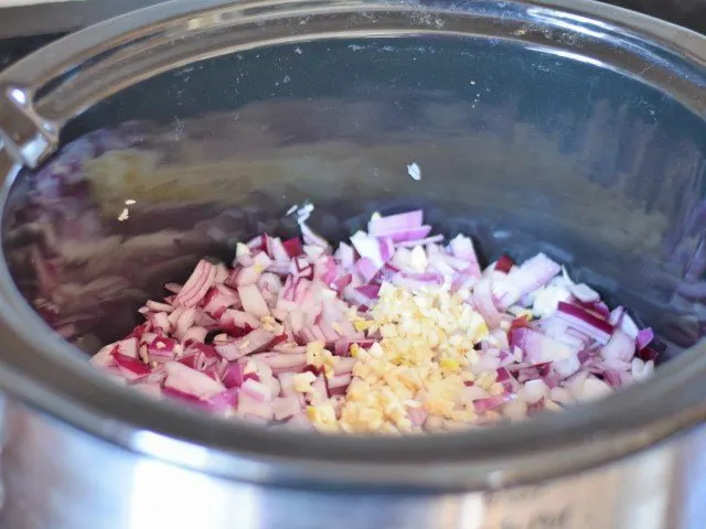Add onion and garlic to crockpot