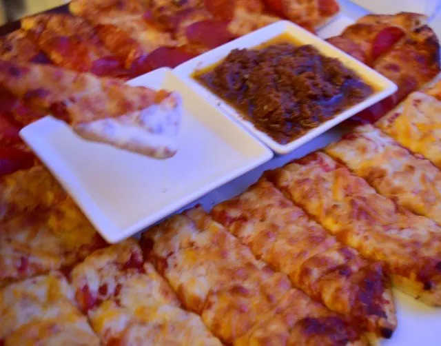 Dipping pizza in creamy garlic pizza dipping sauces