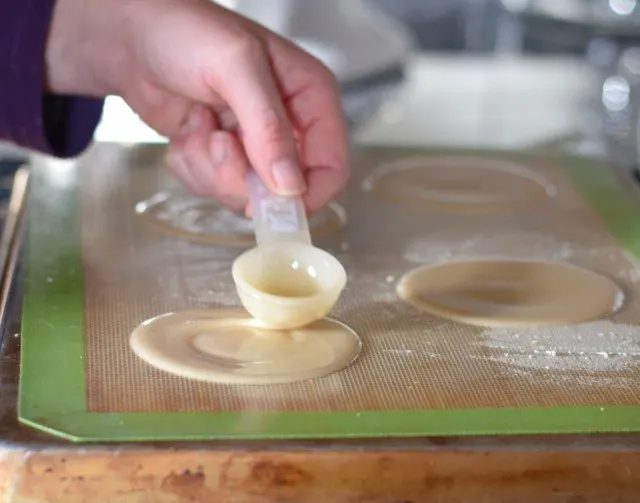 Add four homemade fortune cookies to your baking sheet at a time