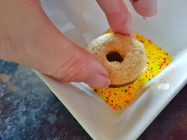 Dip donut into sprinkles but don't press