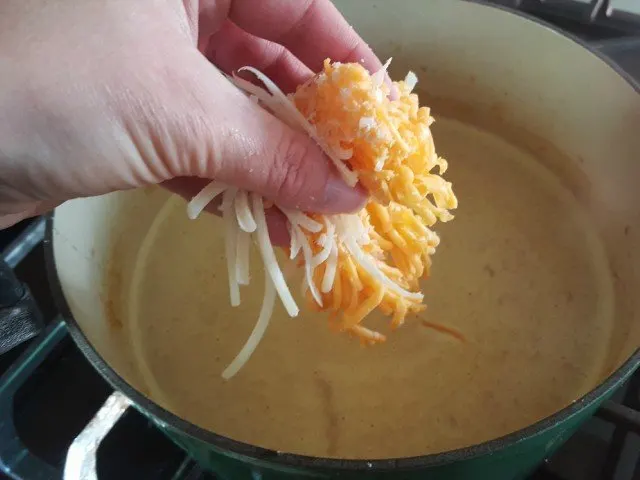 Add cheese just a little at a time to melt in soup