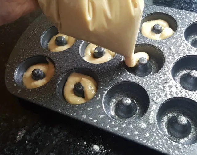 Use a zip top bag to pipe donut batter into your pans
