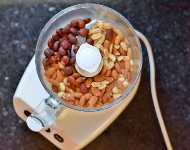 Add nuts to food processor and pulse into a paste