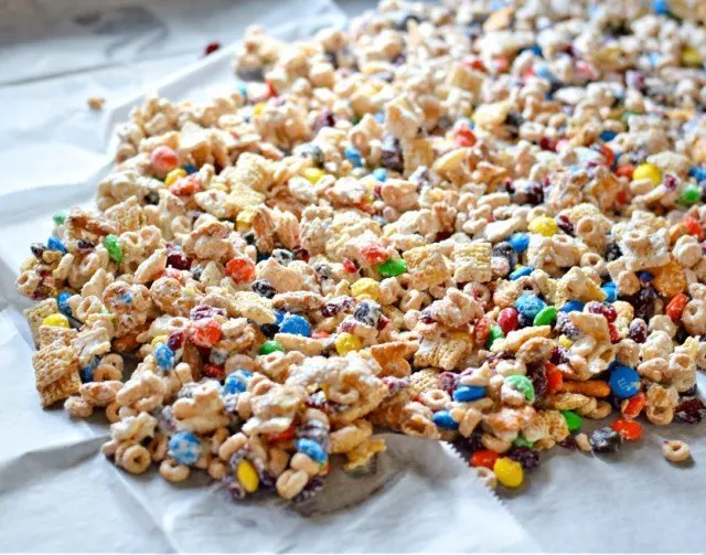 Spread white chocolate party mix on wax paper to harden