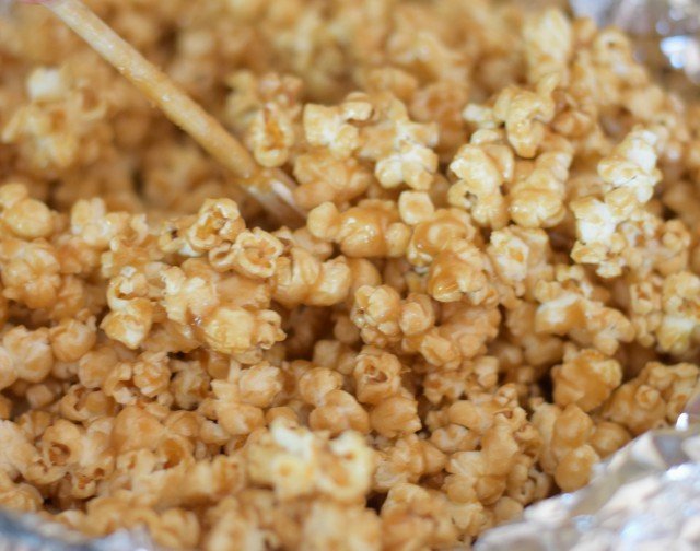 Stir the popcorn while baking