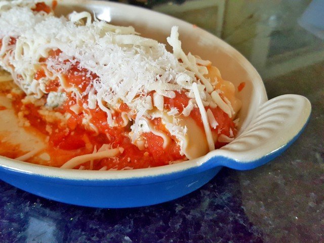 Top lasanga roll ups with more mozzarella and parmesan