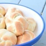 This recipe for pillowy soft homemade dinner rolls is easy to make and provides foolproof tender dinner rolls. This is a great Thanksgiving side dish or perfect for Christmas dinner or any other get together. Bonus step by step tutorial showing how to shape the dough into these gorgeous dinner roll knots.