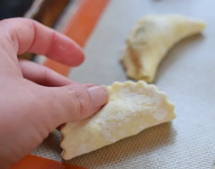Fold dough over the empanada filling