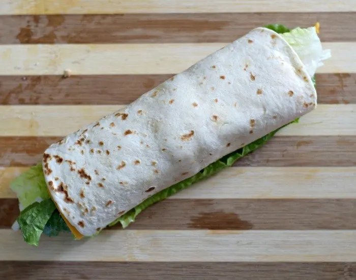 Roll chicken taco wraps tightly into a cylinder