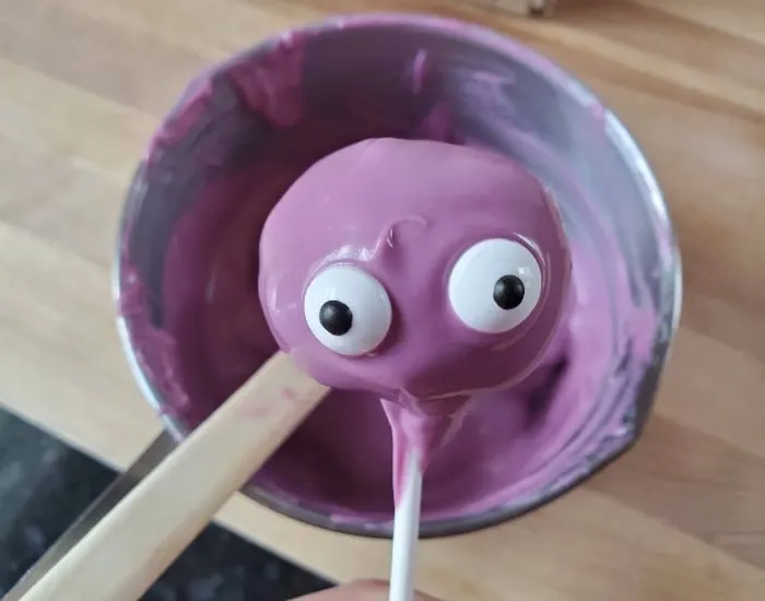 Add eyes immediately after dipping in chocolate