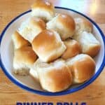 Bowl of yeast dinner rolls on wood background