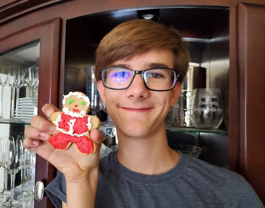 Boy holding up a gingerbread man